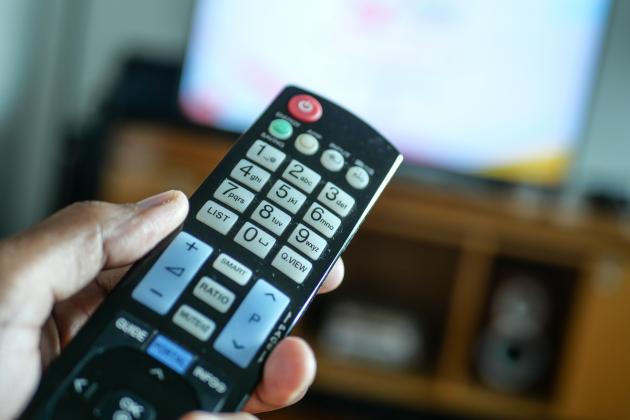 close-up-of-man-hand-holding-tv-remote-2022-09-23-23-36-31-utc