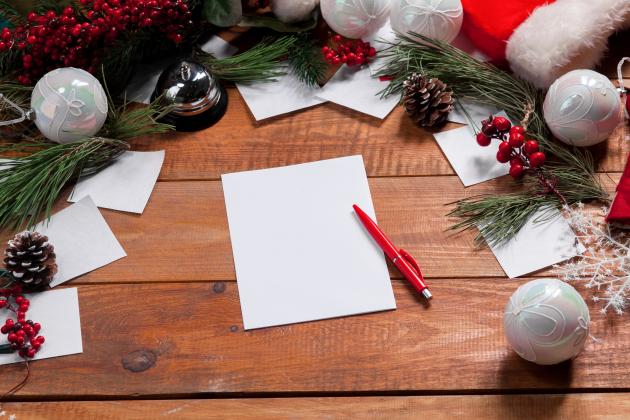 blank-sheet-paper-wooden-table-with-pen-christmas-decorations