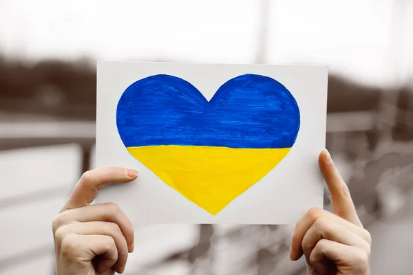 depositphotos_67137239-stock-photo-hands-holding-paper-heart-with