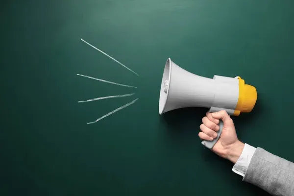 depositphotos_190853948-stock-photo-man-holding-megaphone-near-chalkboard