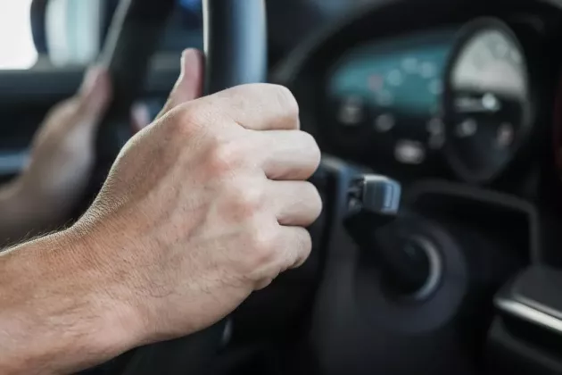 hands-on-steering-wheel-of-car-photo