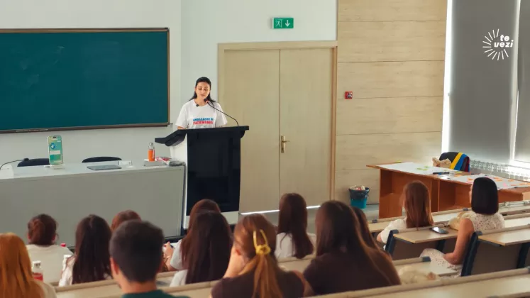Femeie vorbind la podium în clasă
