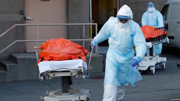 FILE PHOTO: Healthcare workers wheel the bodies of deceased people from the Wyckoff Heights Medical Center during the outbreak of the coronavirus disease (COVID-19) in the Brooklyn borough of New York City, New York, U.S., April 4, 2020. REUTERS/Andrew Ke