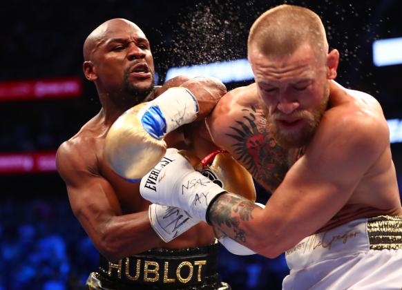 Aug 26, 2017; Las Vegas, NV, USA; Floyd Mayweather Jr. lands a hit against Conor McGregor during their boxing match at the at T-Mobile Arena. Mandatory Credit: Mark J. Rebilas-USA TODAY Sports