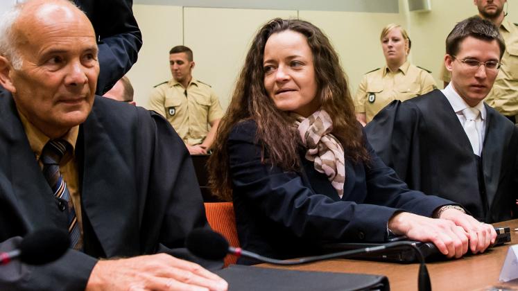 MUNICH, GERMANY - DECEMBER 9: Beate Zschaepe, the main defendant in the NSU neo-Nazi murder trial, waits with her lawyers Mathias Grasel (R) and Hermann Borchert (L) for day 249 of the trial to start at the Oberlandgericht courthouse on December 9, 2015