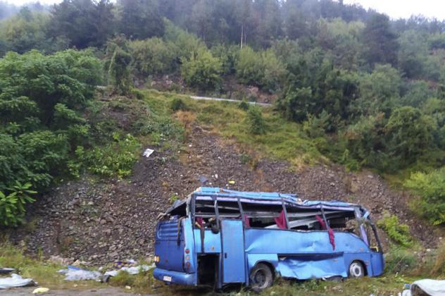 In this handout photo provided by the Bulgarian Interior Ministry, a view of a bus that crashed and overturned, near the town of Svoge, Saturday, Aug. 25, 2018.  Bulgaria's health minister says a tourist bus has flipped over on a highway near Sofia, the c