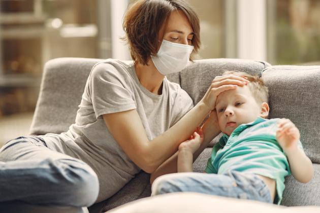 canva-mother-checking-his-son-if-he-has-fever