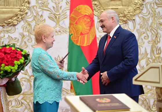 MINSK, BELARUS - SEPTEMBER 23, 2020: Lidiya Yermoshina (L), Chairperson of the Belarusian Central Election Commission, hands over a presidential ID to Belarus' President-Elect Alexander Lukashenko during his inauguration ceremony at the Palace of Independ
