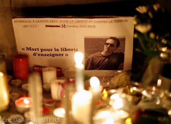 Candles are lit at a makeshift memorial as people gather to pay homage to Samuel Paty, the French teacher who was beheaded on the streets of the Paris suburb of Conflans-Sainte-Honorine, as part of a national tribute, in Nice, France, October 21, 2020. RE