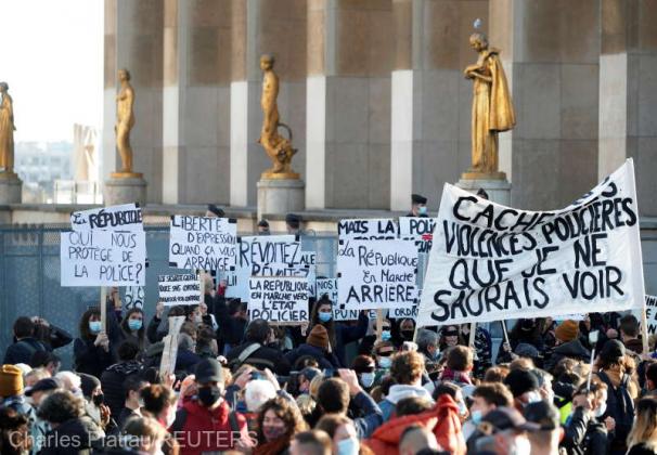 Demonstrators hold up placards during a protest against a bill that would make it a crime to circulate an image of a police officer's face, at Trocadero square, in Paris, France, November 21, 2020. REUTERS/Charles Platiau