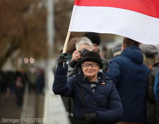 Opposition activist Nina Baginskaya waves a historical white-red-white flag of Belarus during a rally to reject the presidential election results in Minsk, Belarus November 8, 2020. REUTERS/Stringer