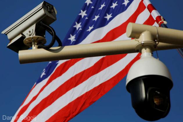 FILE PHOTO: Security cameras are seen in front of a U.S. flag placed near the Forbidden City, ahead of a visit by U.S. President Donald Trump to Beijing, China November 8, 2017. REUTERS/Damir Sagolj/File Photo