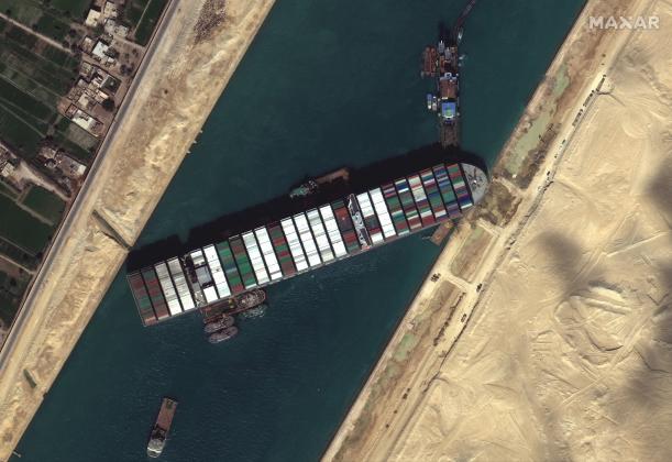 This satellite imagery released by Maxar Technologies shows tug boats and dredgers on March 27, 2021, attempting to free the Taiwan-owned MV Ever Given lodged sideways and impeding all traffic across Egypt's Suez Canal. The container ship, which is longer