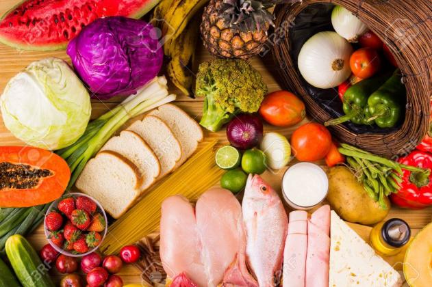 table full of all kinds of food in our daily diet includes proteins, carbohydrates, fats, vegetables and fruits
