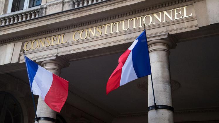 A photo taken on October 15, 2018 shows French flags outside the headquarters of the French Constitutional Council (Conseil Constitutionnel) in Paris. (Photo by BERTRAND GUAY / AFP)
