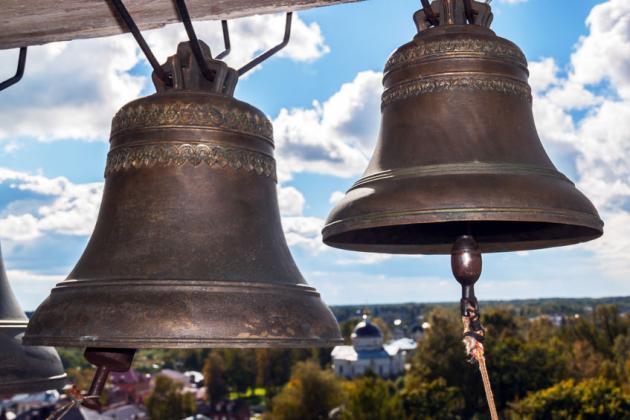 Ancient church bells. Old church and blue sky with clouds in the background