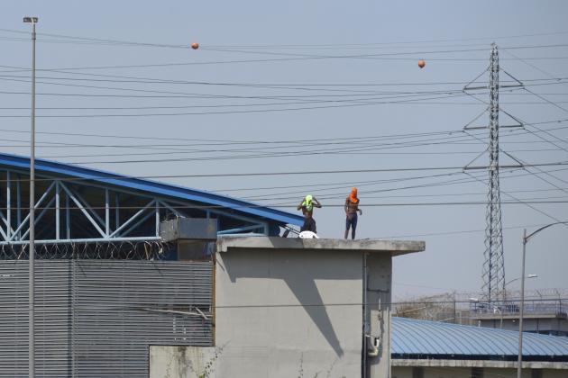 Mandatory Credit: Photo by Marcos Pin/EPA-EFE/Shutterstock (12483432a)
Several inmates remain on the roofs of the Deprivation of Liberty Center Number 1 where there has been a riot, in Guayaquil, Ecuador, 28 September 2021. At least 24 inmates have died a