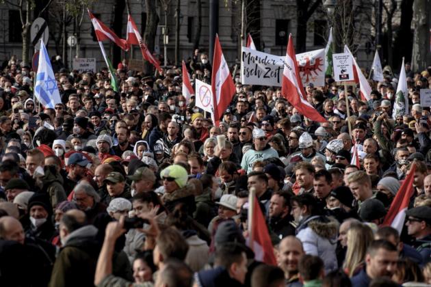 epa09593303 People take part in a demonstration against the measures of the Austrian government to slow down the ongoing pandemic of the COVID-19 disease caused by the SARS-CoV-2 coronavirus at the Heldenplatz square in Vienna, Austria, 20 November 2021.
