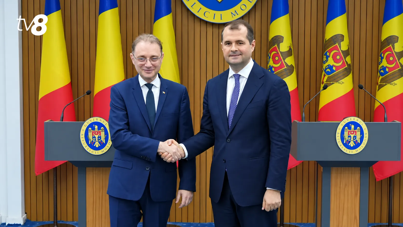 Official handshake at a televised briefing